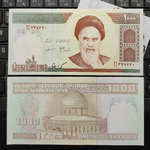 uang kertas iran dengan gambar tokoh sejarah dan simbol keagamaan